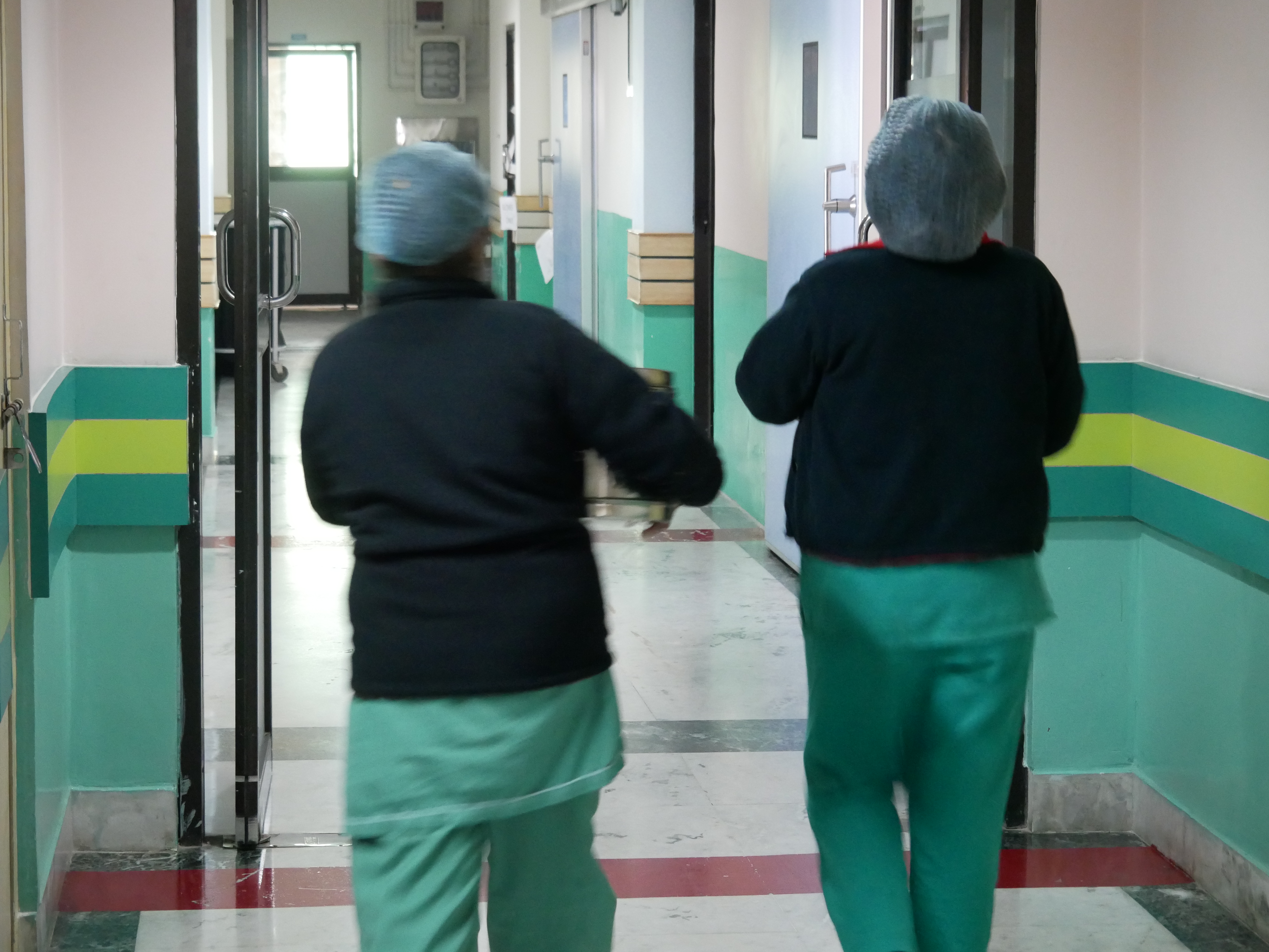 two nurses rushing through the hallway