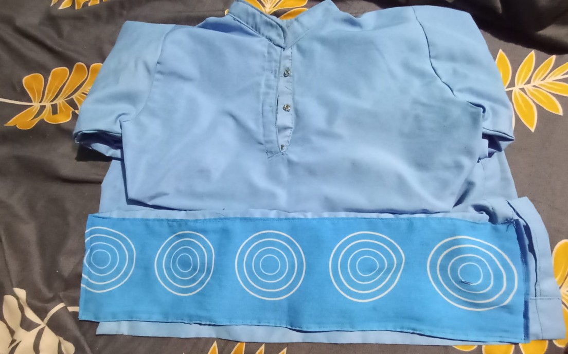 a blue dress decorated with white circles