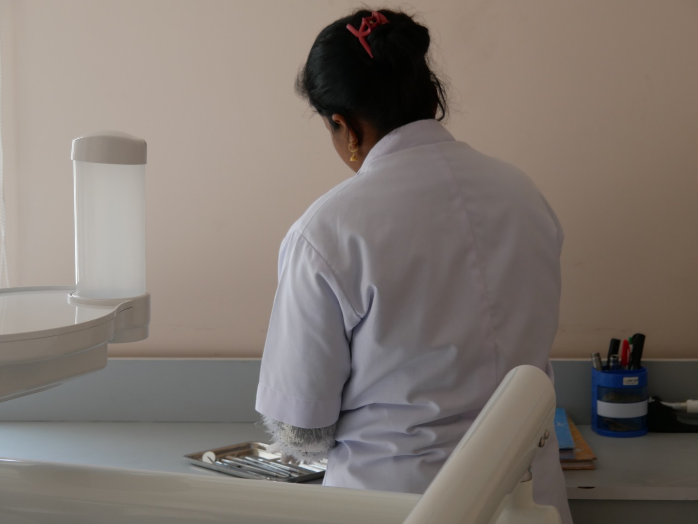 a nurse preparing equipment for dental care