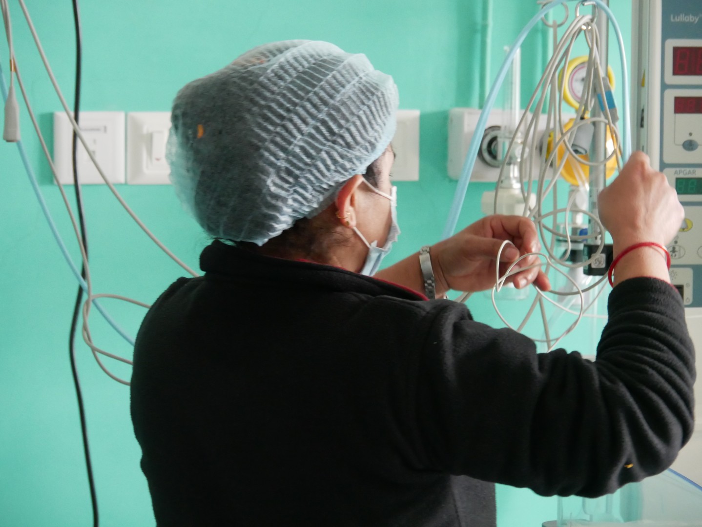 a nurse untangling tubes